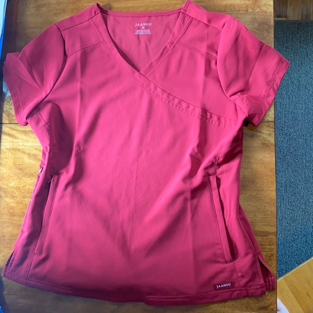 Women’s Jaanuu scrub set in garnet. Size MEDIUM.